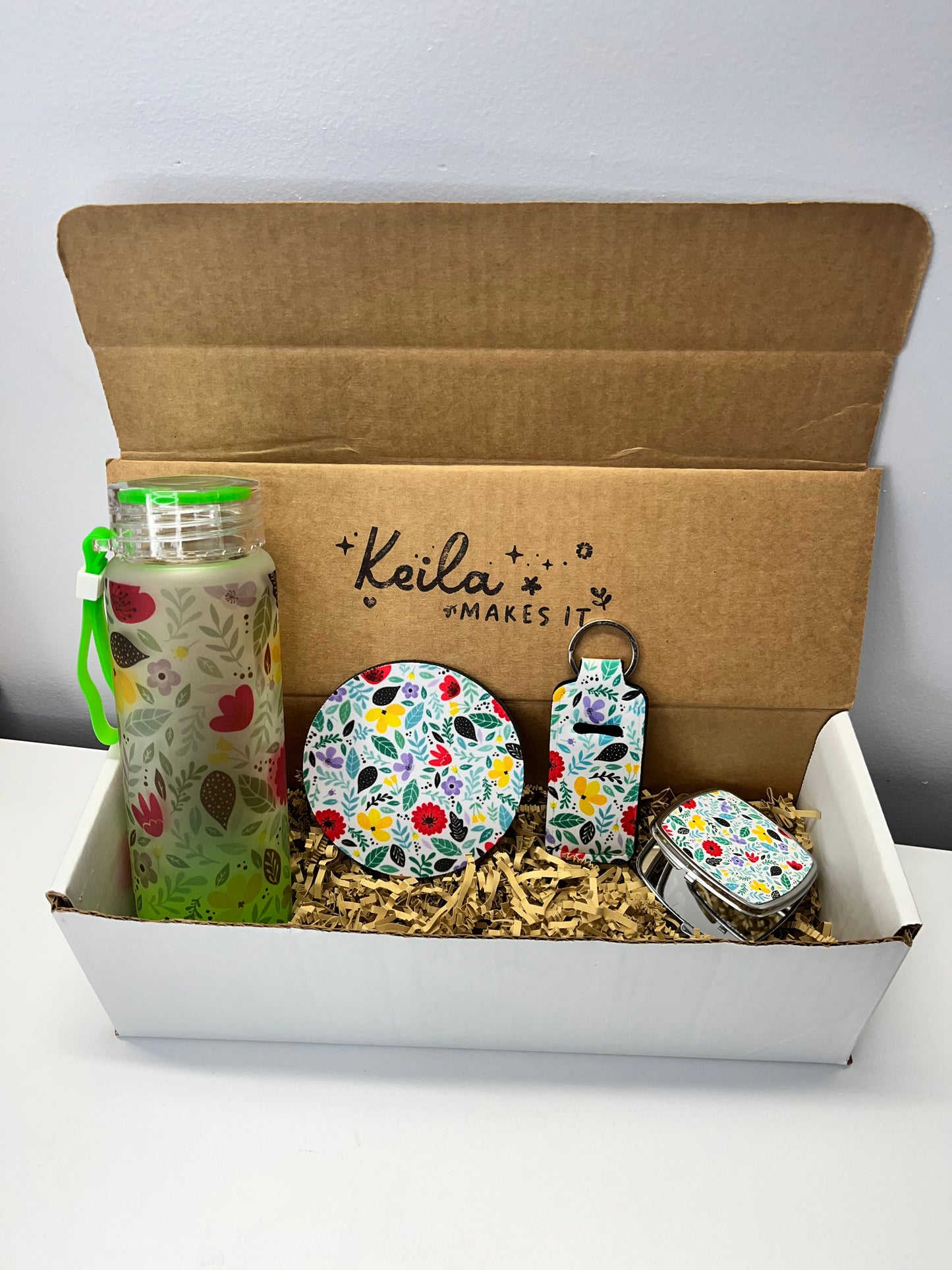 Wildflower bliss bundle gift box. Includes a 16 oz frosted glass bottle, coaster, keychain lipstick holder and a portable mirror.